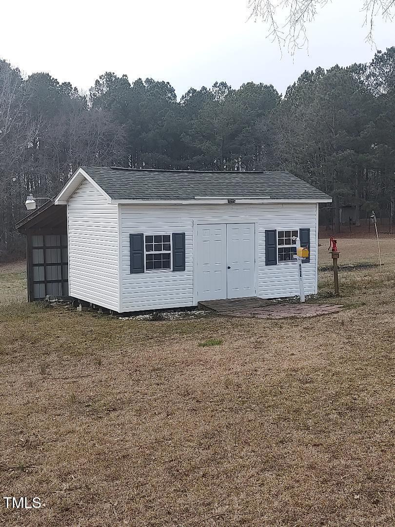 2960 Federal Road Benson, NC 27504 - Photo 12 of 45 Back Yard Storage Building is wired, and has a nice shelter off the back side!~~MAN CAVE~~~SHE SHED~~Possibilities