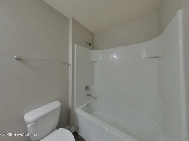 a bathroom with a toilet and a bathtub