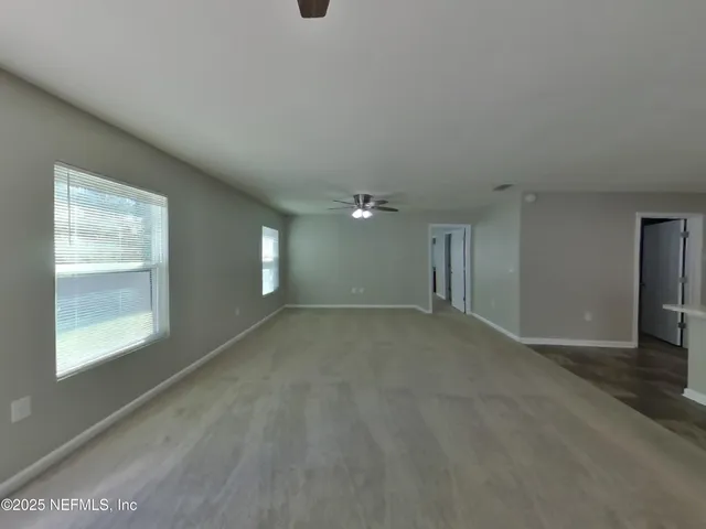 an empty room with windows and closet