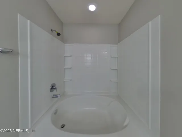 a white bath tub sitting in a bathroom