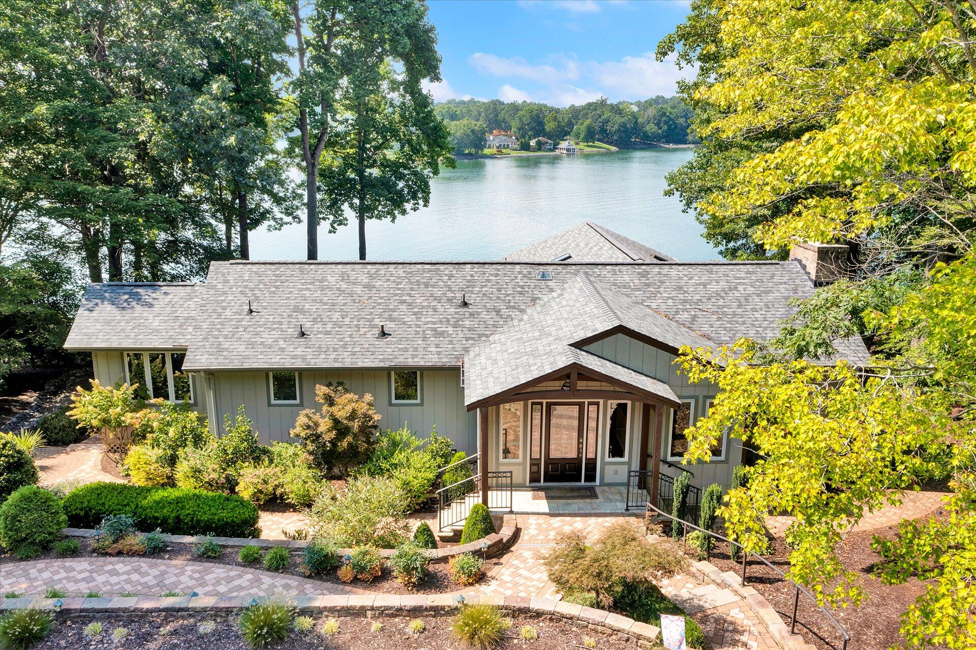 85 Chickadee Circle Moneta, VA 24121 - Photo 1 of 57 a front view of a house with garden and lake view