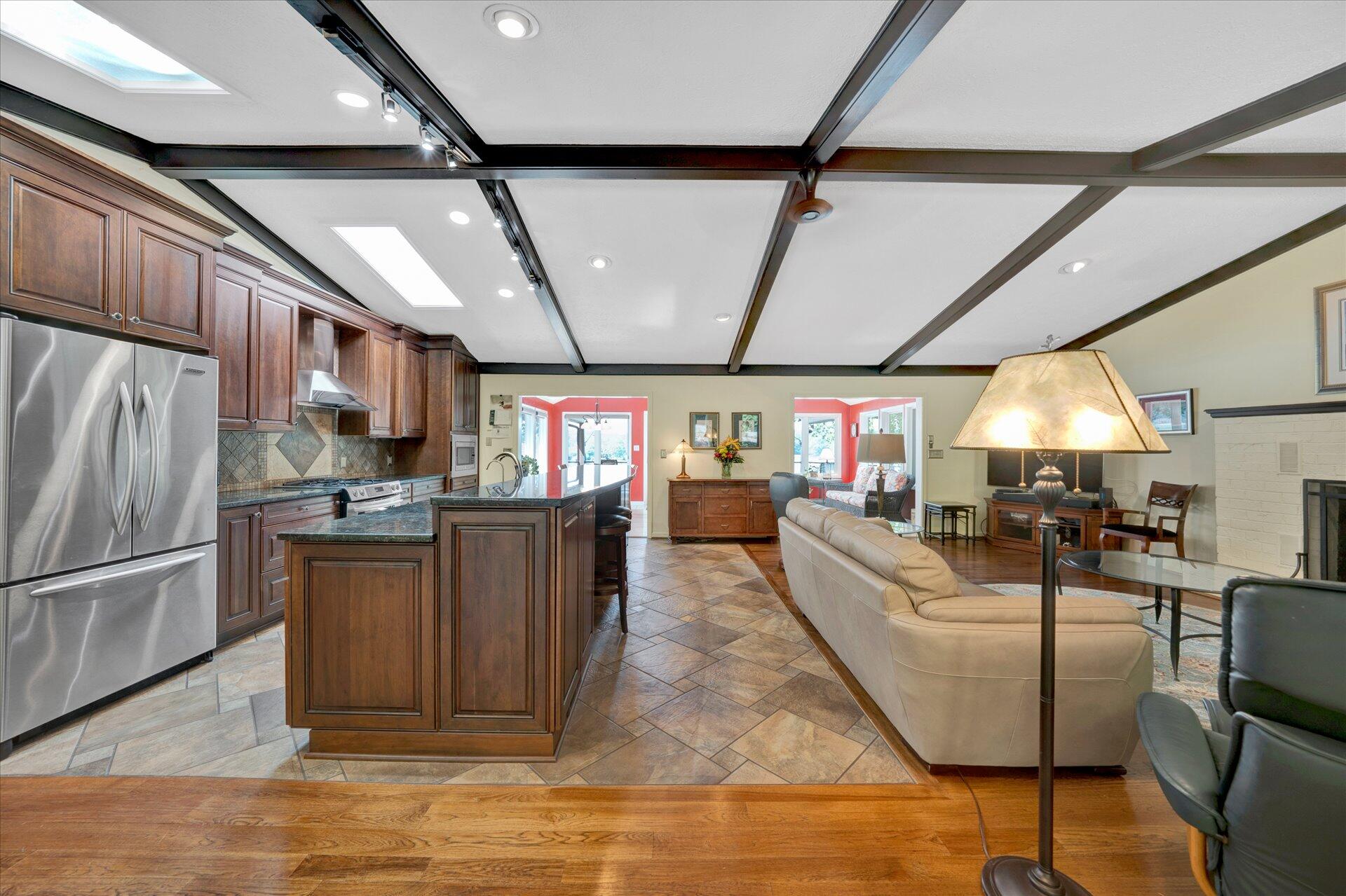 85 Chickadee Circle Moneta, VA 24121 - Photo 11 of 57 a kitchen with stainless steel appliances granite countertop a refrigerator a sink dishwasher a stove and a dining table with wooden floor