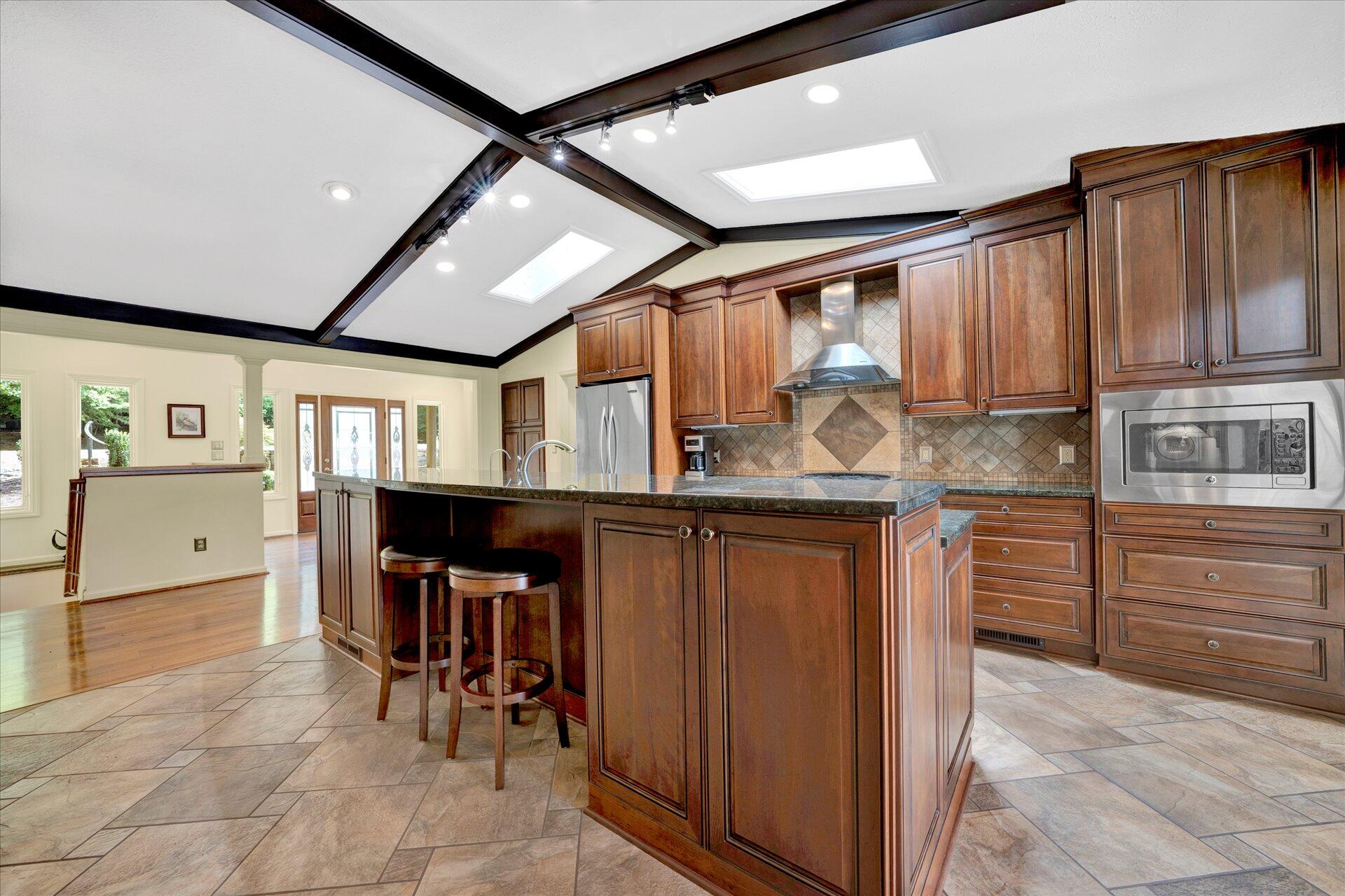 85 Chickadee Circle Moneta, VA 24121 - Photo 12 of 57 a kitchen with stainless steel appliances granite countertop a refrigerator and wooden cabinets