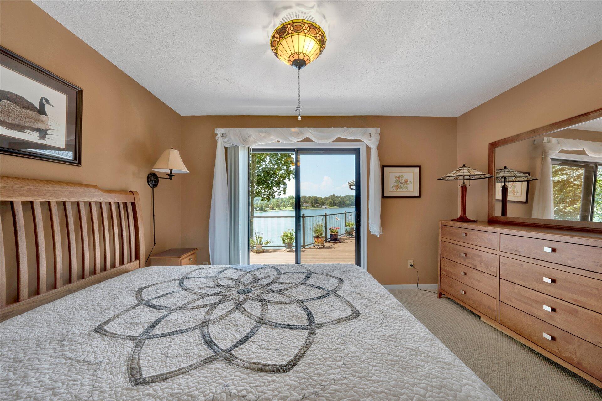 85 Chickadee Circle Moneta, VA 24121 - Photo 25 of 57 a bed room with a bed and a chandelier