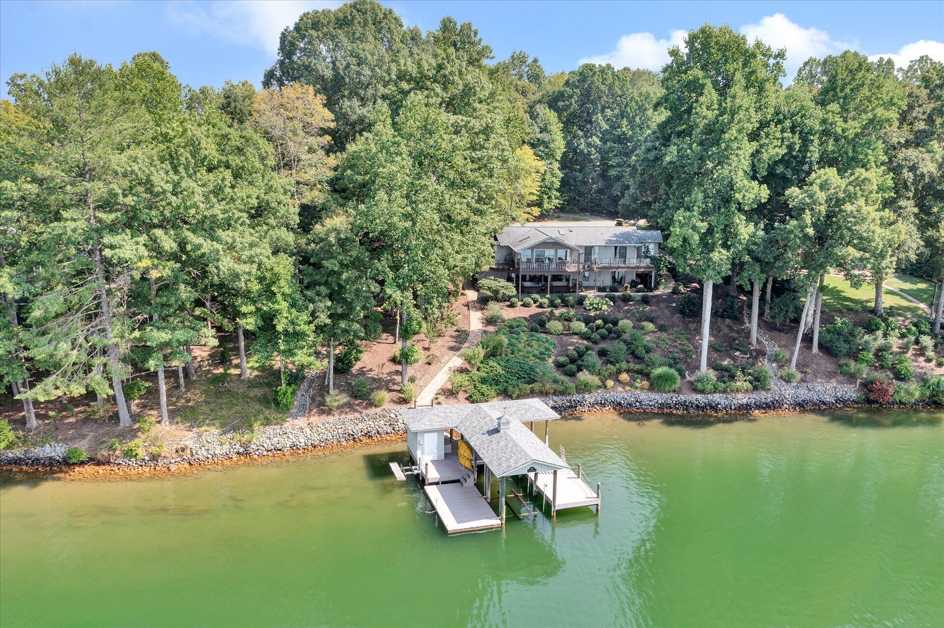 85 Chickadee Circle Moneta, VA 24121 - Photo 5 of 57 a wooden bench sitting in the middle of a lake