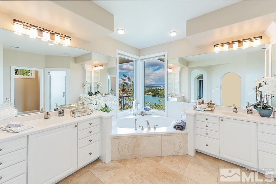 2849 Mountain Springs Road Reno, NV 89519 - Photo 18 of 25 a large bathroom with a double vanity sink large mirror and a bathtub