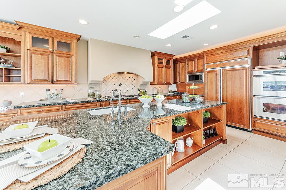 2849 Mountain Springs Road Reno, NV 89519 - Photo 7 of 25 a kitchen with stainless steel appliances granite countertop a stove and a sink