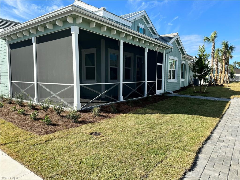 7289 Saona Court Naples, FL 34113 - Photo 12 of 17 a front view of a house with a yard
