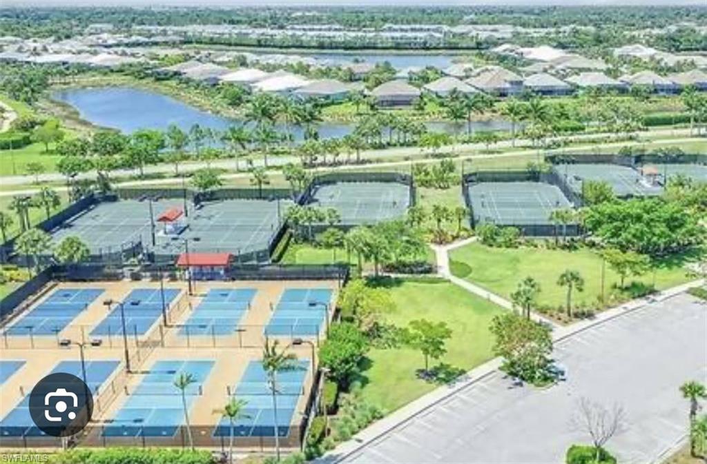 7289 Saona Court Naples, FL 34113 - Photo 16 of 17 an aerial view of residential houses with outdoor space and lake view