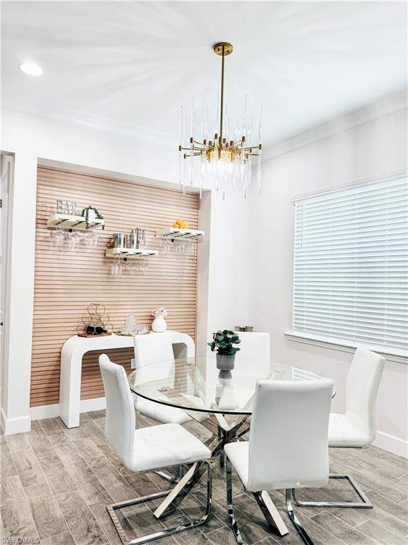 7289 Saona Court Naples, FL 34113 - Photo 5 of 17 a view of a dining room with furniture and a chandelier