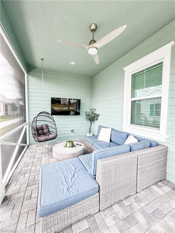 7289 Saona Court Naples, FL 34113 - Photo 6 of 17 a living room with furniture and a flat screen tv