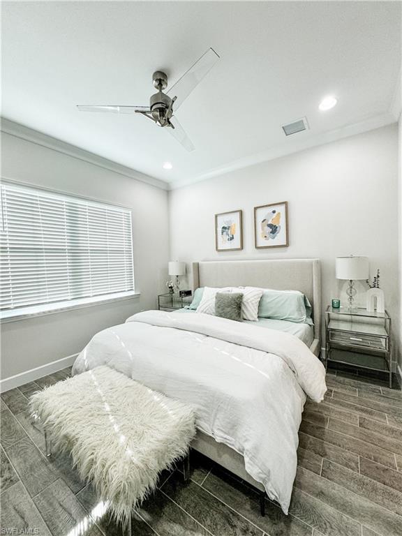 7289 Saona Court Naples, FL 34113 - Photo 7 of 17 a bedroom with a bed and a large window