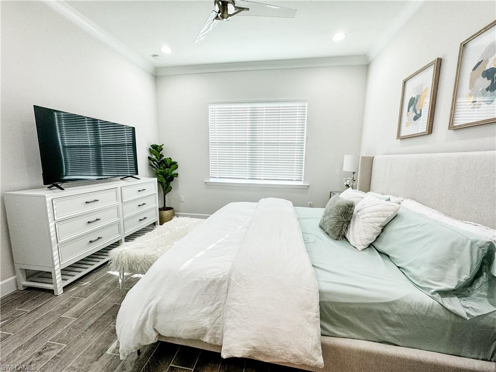 7289 Saona Court Naples, FL 34113 - Photo 8 of 17 a bedroom with a bed and tv