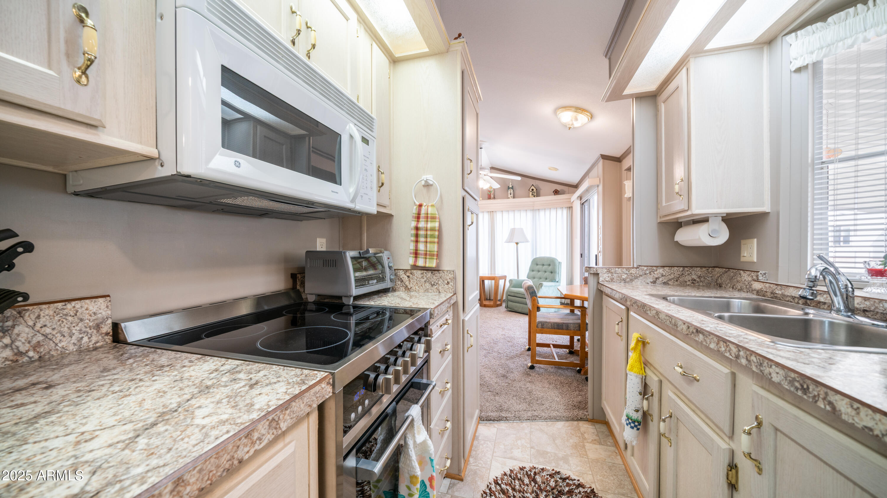 3 Ore Cart Drive, Unit 3 Apache Junction, AZ 85119 - Photo 16 of 59 a kitchen with stainless steel appliances granite countertop a sink stove and cabinets