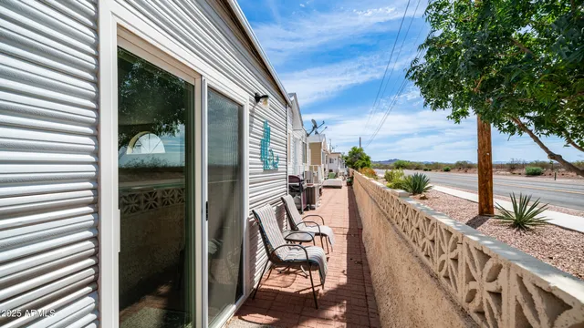 a view of a house with a yard table and chairs