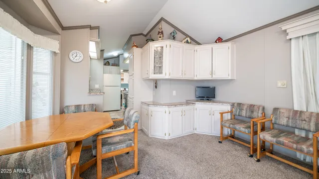 a kitchen with a sink a refrigerator and cabinets