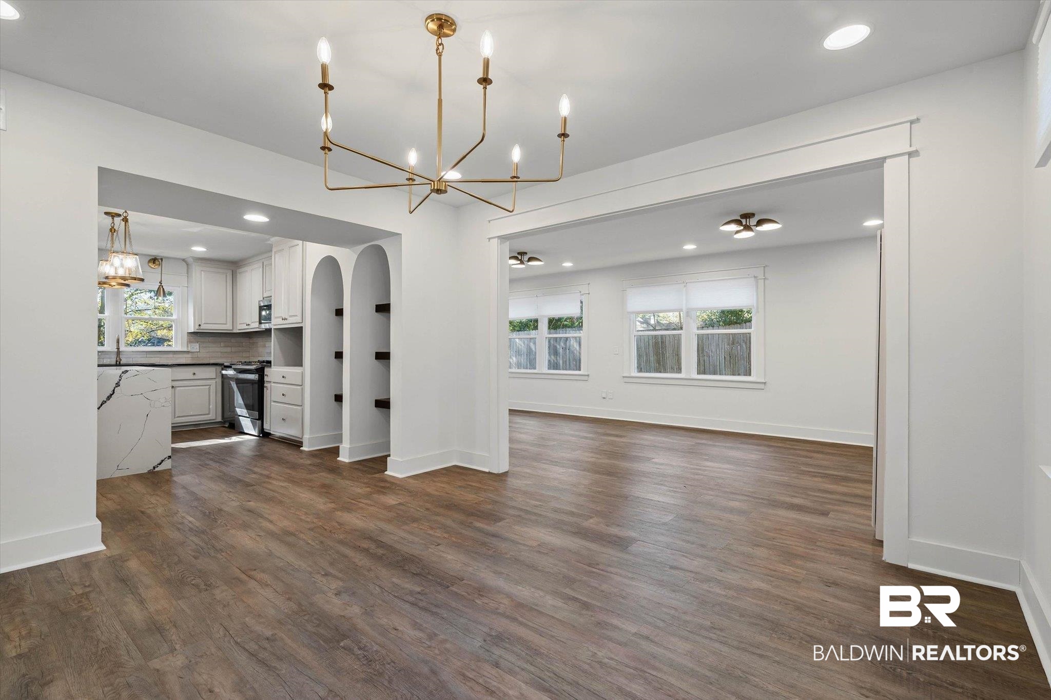 3933 Radnor Avenue Mobile, AL 36608 - Photo 6 of 36 The Dining area featuring a chandelier, dark wood-style flooring, recessed lighting, and arched walkways gives just one of the options for placement of your Dining Area .. Trade this space for the living area and ... there you have it .. see it? Live it!