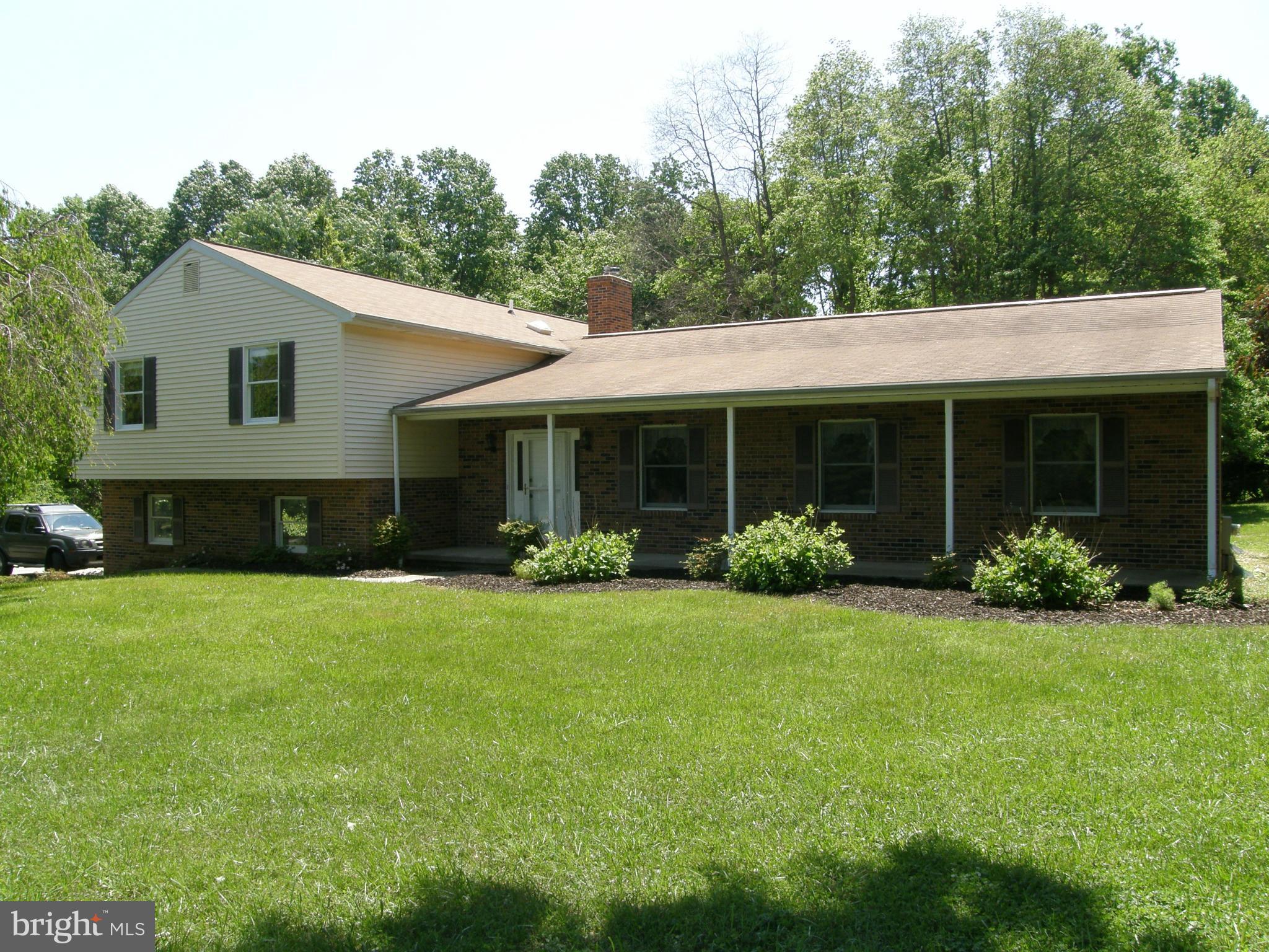 5603 Sweet Air Road Baldwin, MD 21013 - Photo 1 of 30 a front view of a house with a garden and porch