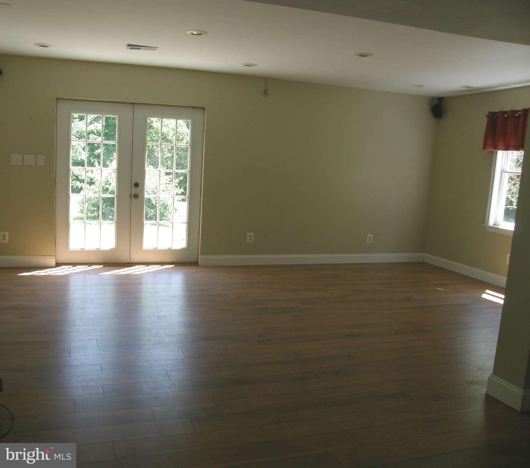 5603 Sweet Air Road Baldwin, MD 21013 - Photo 15 of 30 an empty room with wooden floor and windows with curtains