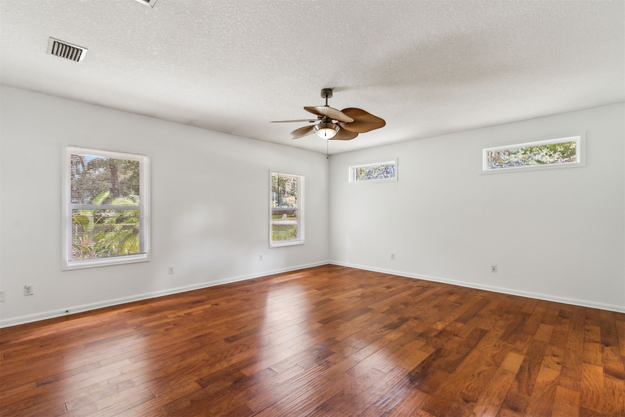 2441 Amelia Road Fernandina Beach, FL 32034 - Photo 25 of 36 a view of an empty room with window and wooden floor
