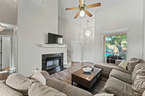 a living room with furniture a fireplace and a flat screen tv