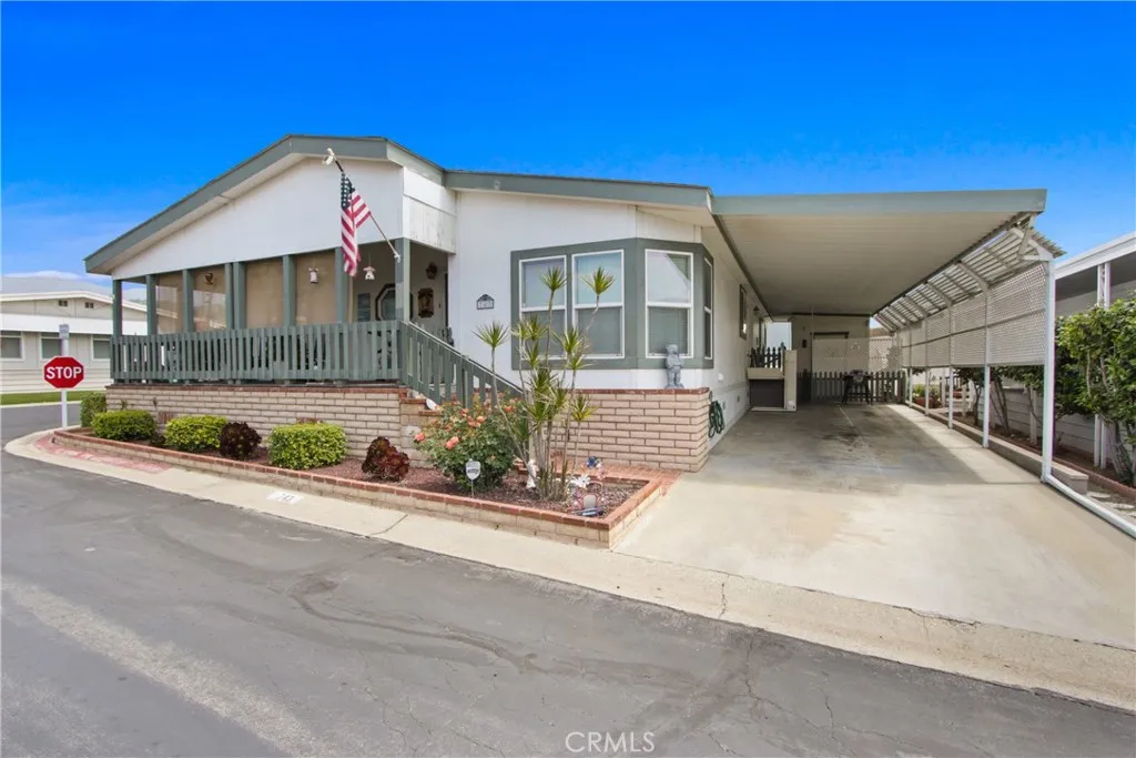 a front view of a house with a yard and potted plants