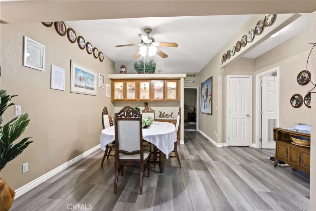 4095 Fruit La, Unit 743 La Verne, CA 91750 - Photo 14 of 21 a view of a dining room with furniture a chandelier and wooden floor