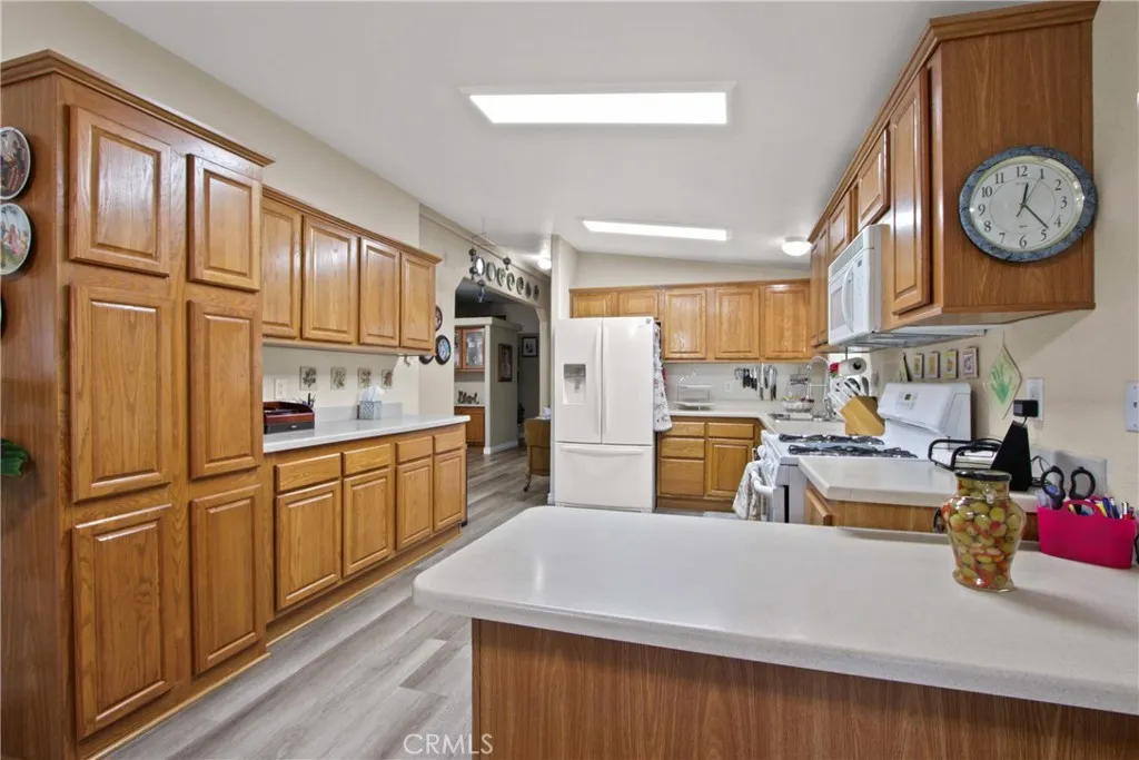4095 Fruit La, Unit 743 La Verne, CA 91750 - Photo 8 of 21 a kitchen with stainless steel appliances granite countertop a refrigerator a stove and a sink with cabinets