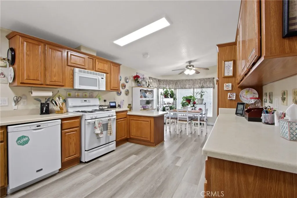 4095 Fruit La, Unit 743 La Verne, CA 91750 - Photo 9 of 21 a kitchen with stainless steel appliances granite countertop wooden cabinets a stove a sink and a dishwasher
