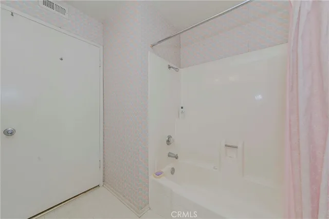 a view of a hallway with washer and dryer