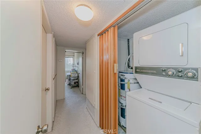 a kitchen with stainless steel appliances a sink cabinets and a window