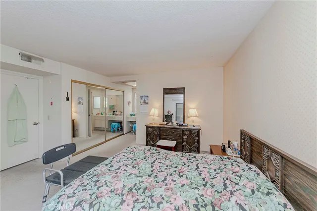 a bedroom with a bed and a dresser in it