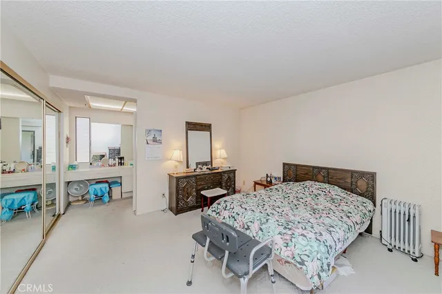 a bedroom with a bed and a table in it