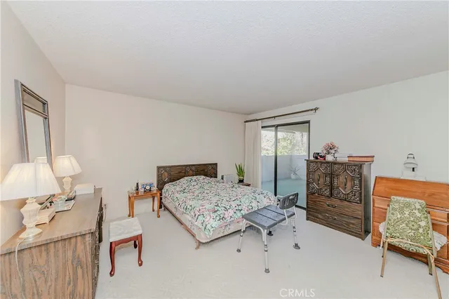 a bedroom with a bed and a dresser in it