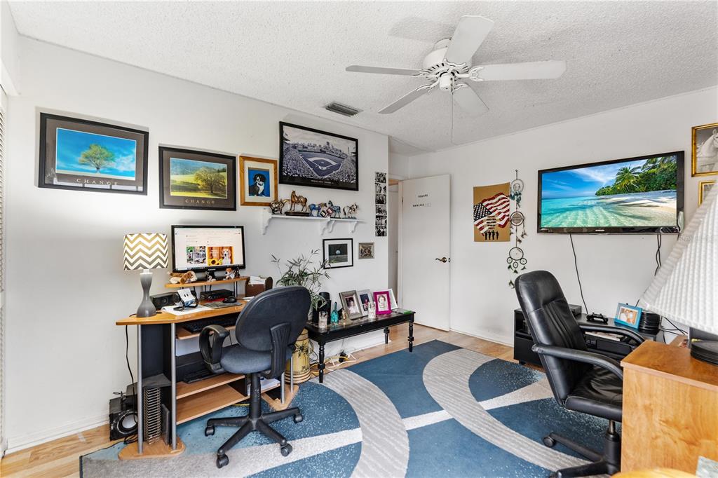 11719 Rose Tree Drive New Port Richey, FL 34654 - Photo 18 of 51 a work room with furniture and a flat screen tv