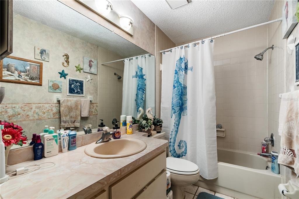 11719 Rose Tree Drive New Port Richey, FL 34654 - Photo 22 of 51 a bathroom with a sink toilet and shower