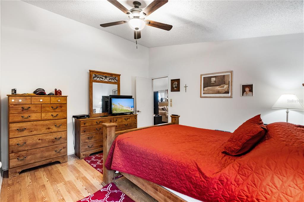 11719 Rose Tree Drive New Port Richey, FL 34654 - Photo 25 of 51 a bedroom with a bed and a dresser