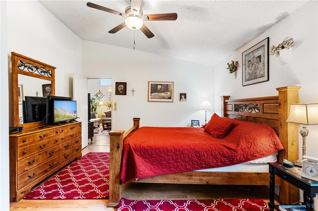 11719 Rose Tree Drive New Port Richey, FL 34654 - Photo 26 of 51 a bedroom with bed and flat tv screen on the dresser