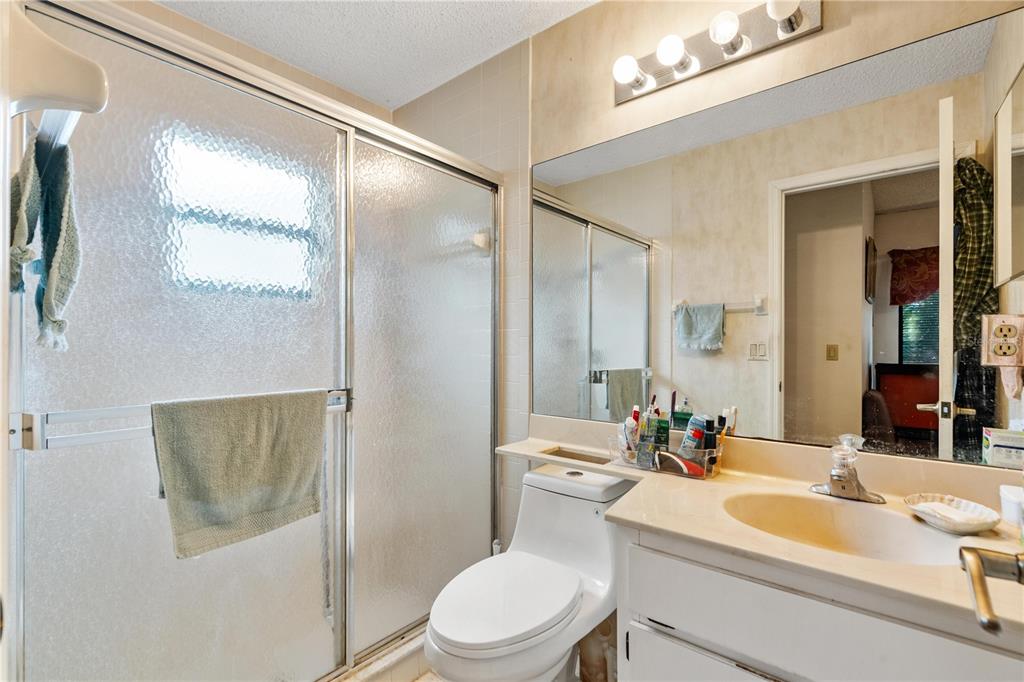 11719 Rose Tree Drive New Port Richey, FL 34654 - Photo 27 of 51 a bathroom with a sink a toilet and shower a mirror