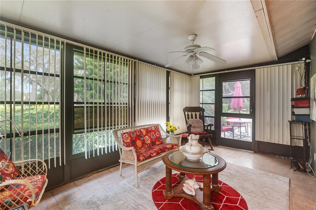 11719 Rose Tree Drive New Port Richey, FL 34654 - Photo 28 of 51 a living room with furniture and a floor to ceiling window