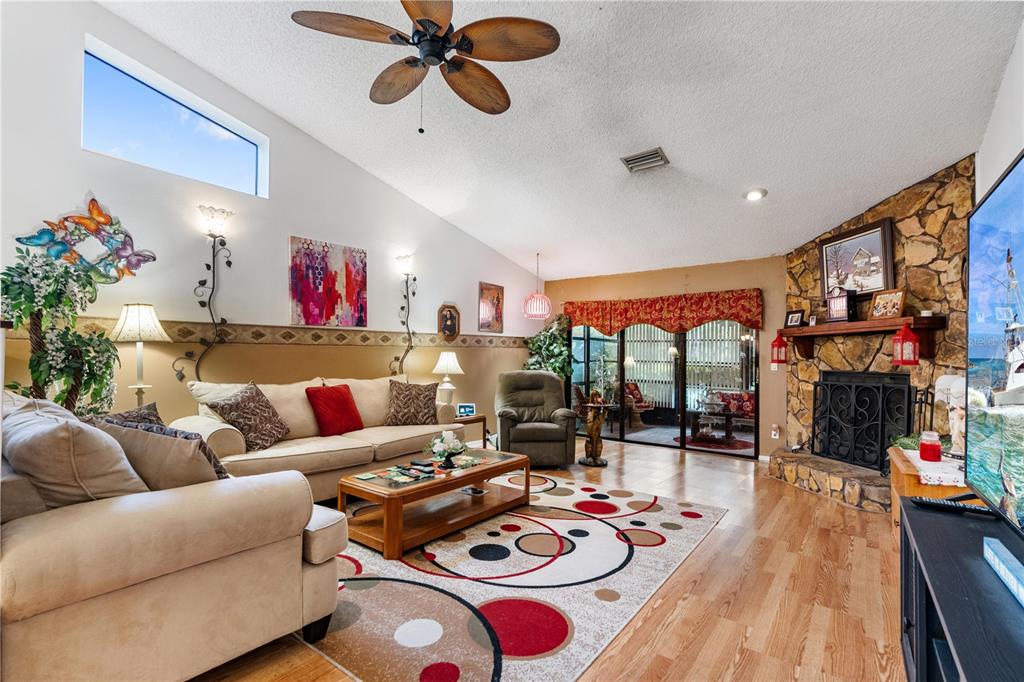 11719 Rose Tree Drive New Port Richey, FL 34654 - Photo 4 of 51 a living room with furniture and a floor to ceiling window