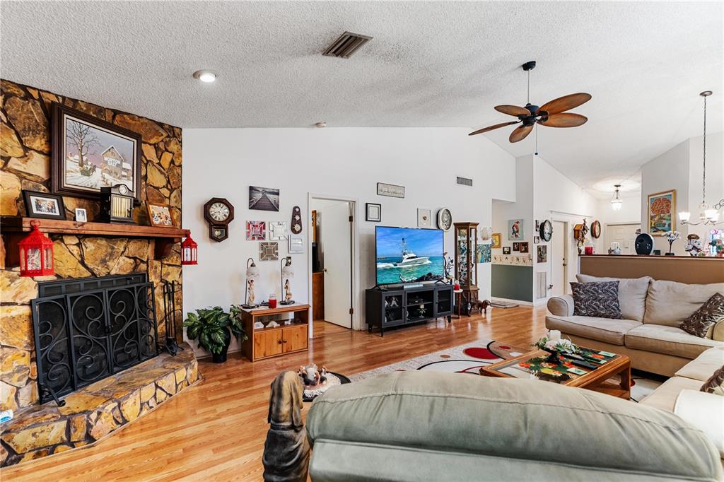 11719 Rose Tree Drive New Port Richey, FL 34654 - Photo 5 of 51 a living room with furniture and a flat screen tv