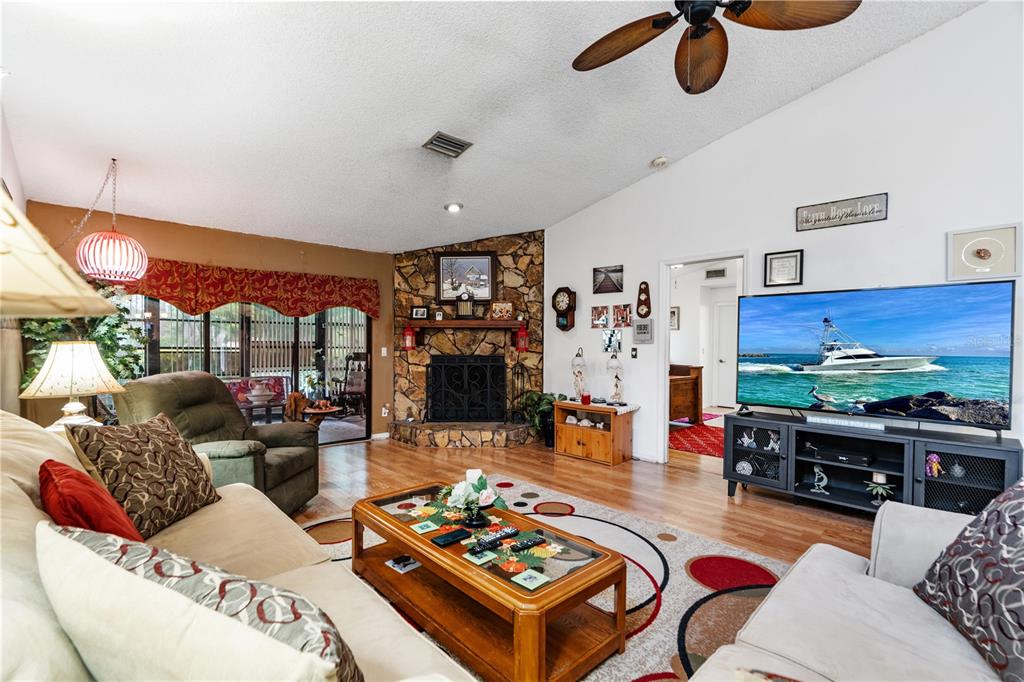 11719 Rose Tree Drive New Port Richey, FL 34654 - Photo 7 of 51 a living room with furniture and a floor to ceiling window
