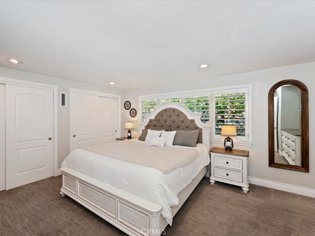 27550 North Bay Road Lake Arrowhead, CA 92352 - Photo 15 of 32 a bedroom with a bed a large window and a dresser