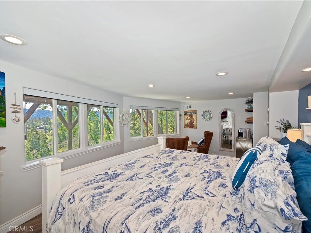 27550 North Bay Road Lake Arrowhead, CA 92352 - Photo 17 of 32 a bed sitting in a bedroom next to a large window