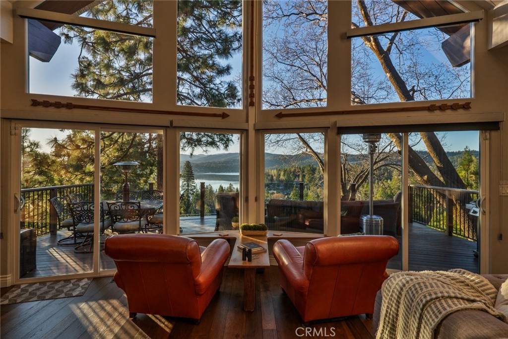 27550 North Bay Road Lake Arrowhead, CA 92352 - Photo 3 of 32 a living room with large glass windows and a table