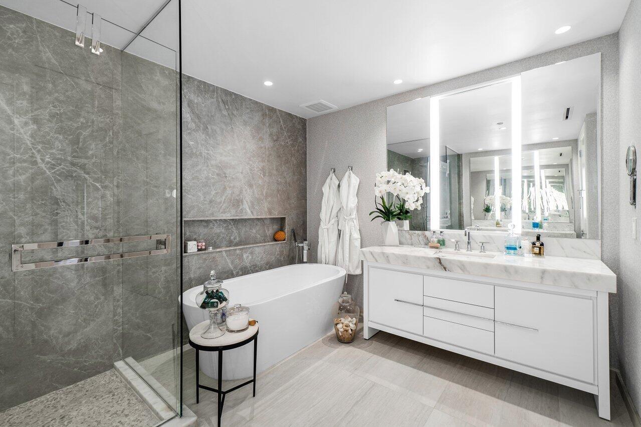 200 Southeast Mizner Boulevard, Unit 211 Boca Raton, FL 33432 - Photo 20 of 67 a spacious bathroom with a tub sink and mirror