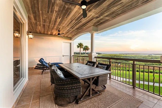 a view of a balcony with furniture and floor to ceiling window