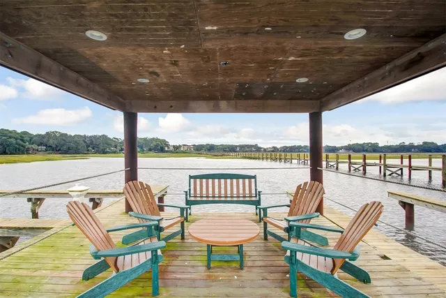 a view of a chairs and table in wooden deck