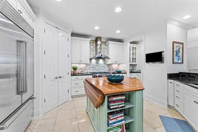 a kitchen with stainless steel appliances granite countertop a sink and a refrigerator